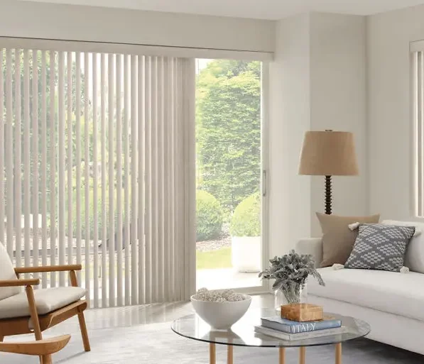 Light-colored Custom Vertical Blinds covering a sliding glass door and a window in a living room.